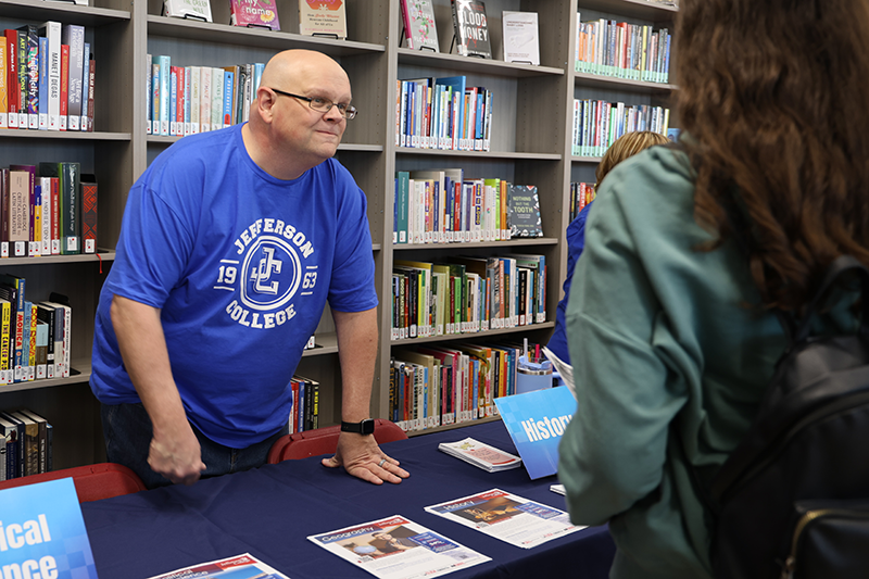 Faculty member talking to student.